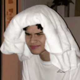 close-up crop of oli xl grimacing with a towel draped on his head