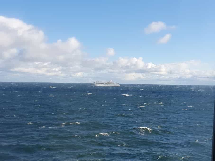 a ship at sea, with some clouds in the sky, seen from a window of the ship i was on