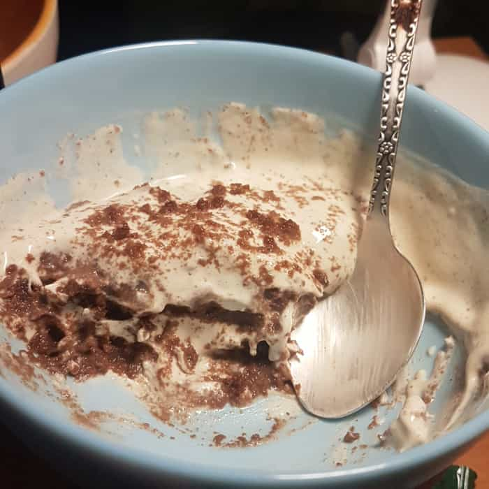 half-eaten biscuit dessert, with alternating layers of sour cream and chocolate biscuit