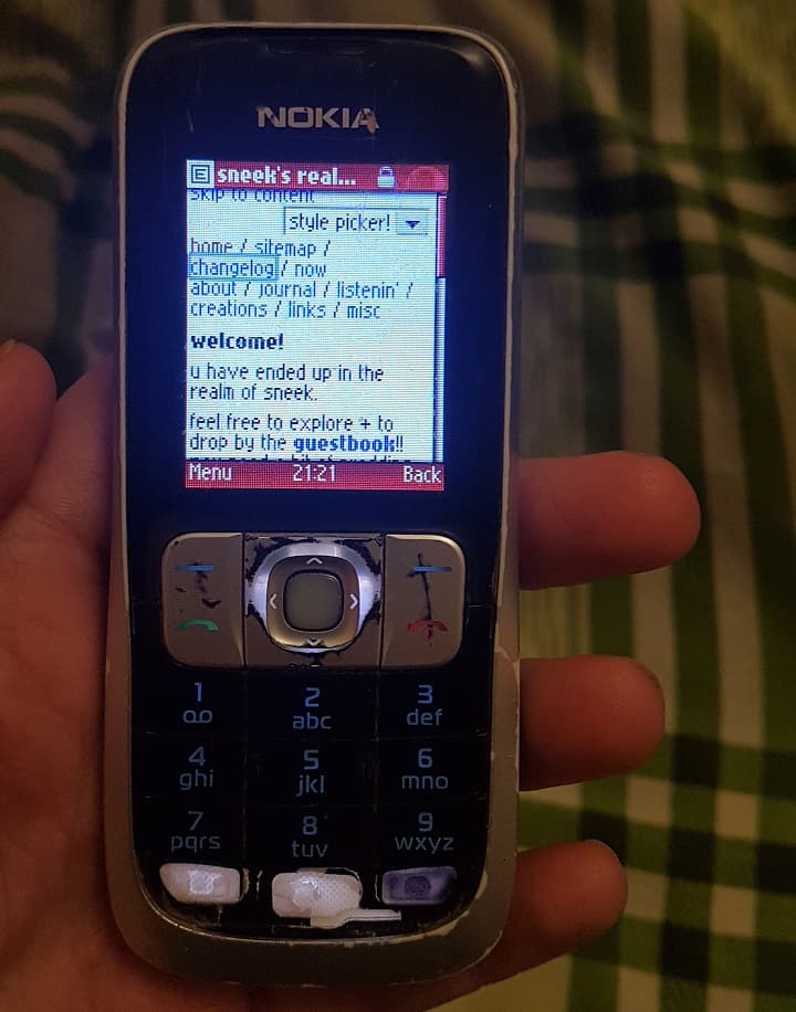 my site's index page rendered in a very basic way on the old worn buttoned phone with a tiny screen